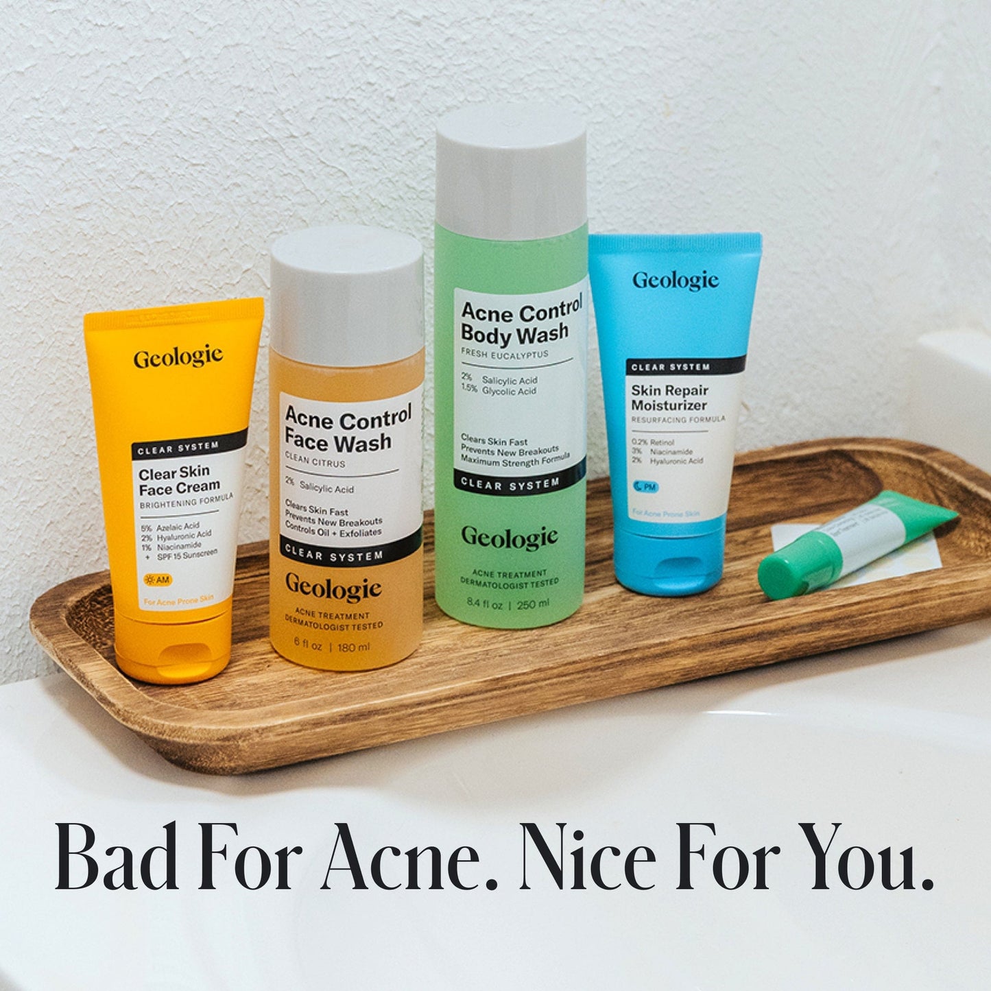 Geologic Complete Clear Skin Repair System on a wooden tray with text 'Bad For Acne. Nice For You.'