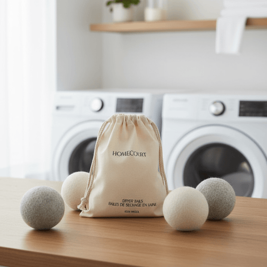 Homecourt 100% wool laundry dryer balls on a wooden surface in a laundry room.