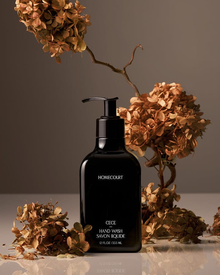 Black pump bottle of award-winning Homecourt Cece Hand Wash with dried cece flowers and branches around it.
