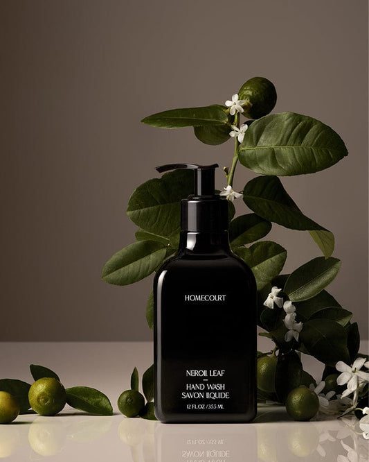 Black pump bottle of award-winning Homecourt Neroli Leaf Hand Wash with neroli branches fruit and blossoms.