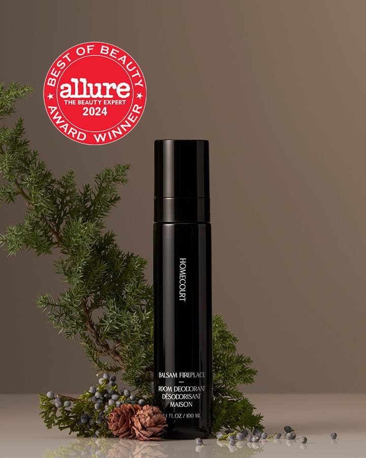 Best of Beauty Allure Award Winner Homecourt Room Deodorizer Balsam Fragrance next to fir branches and pine cones fruit.