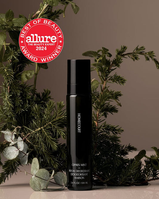 2023 & 2024 Allure Best of Beauty Award Winner Black Homecourt Room Deodorizer next to cipres branches and mint leaves.
