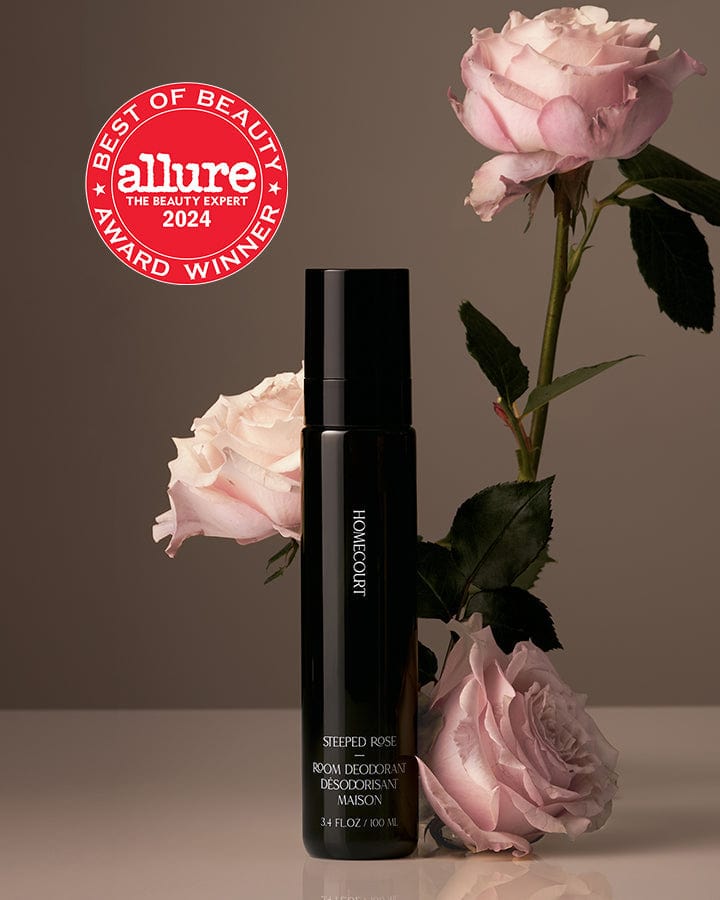 Best of Beauty Allure Award Winner Homecourt Room Deodorizer Steeped Rose Fragrance bottle next to roses.