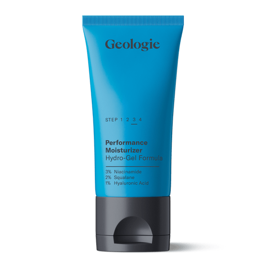 Blue tube of Geologie Performance Moisturizer on a green background.