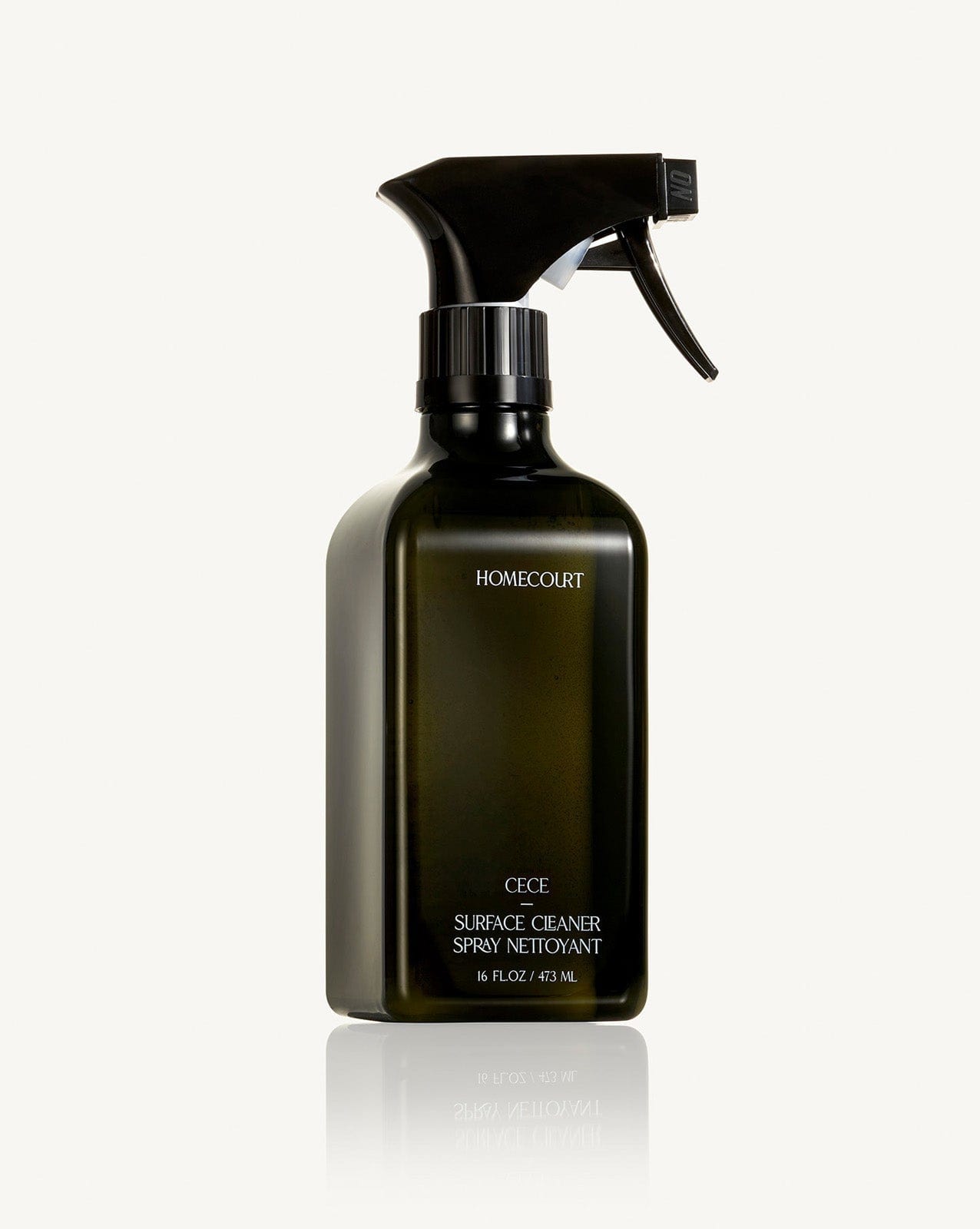 Black spray bottle of Homecourt Natural Surface Cleaner on a white background.