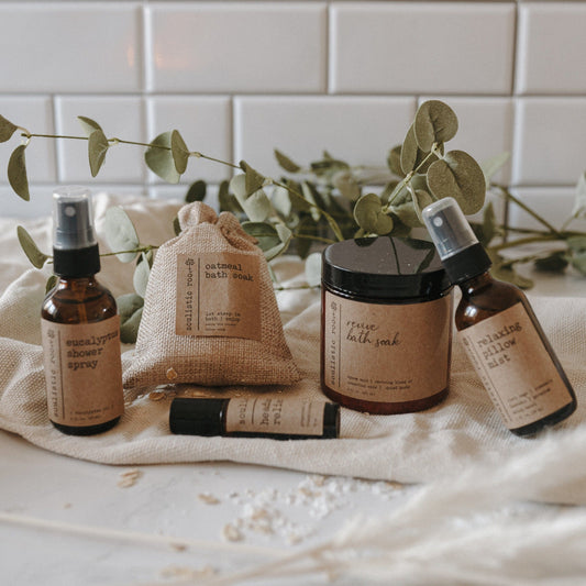 Collection of therapeutic spa natural skincare products with labels on a white surface and tiled wall background.