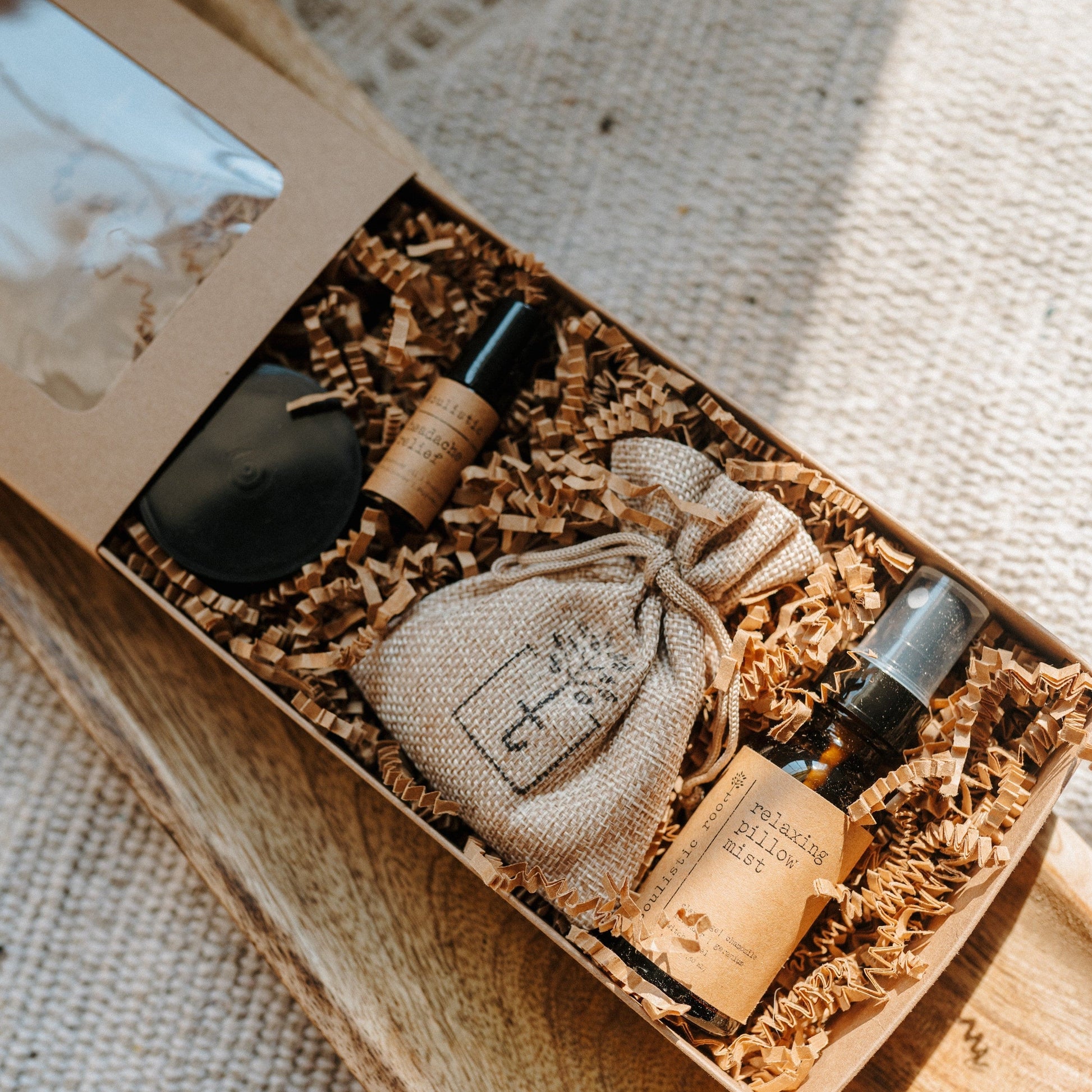 Therapeutic Travel Gift Set products including bottles and a pouch in a box on a textured surface