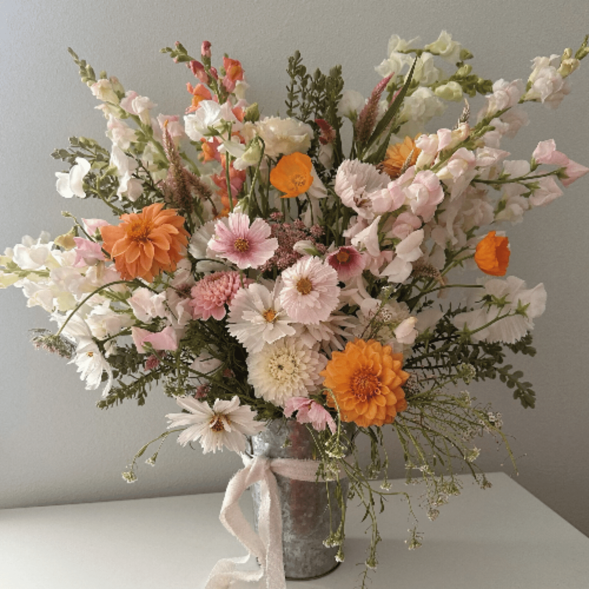 Dahlias, cosmos, snapdragons, poppies and more, grown with organic farming techniques & arranged by Little Mountain Flowers