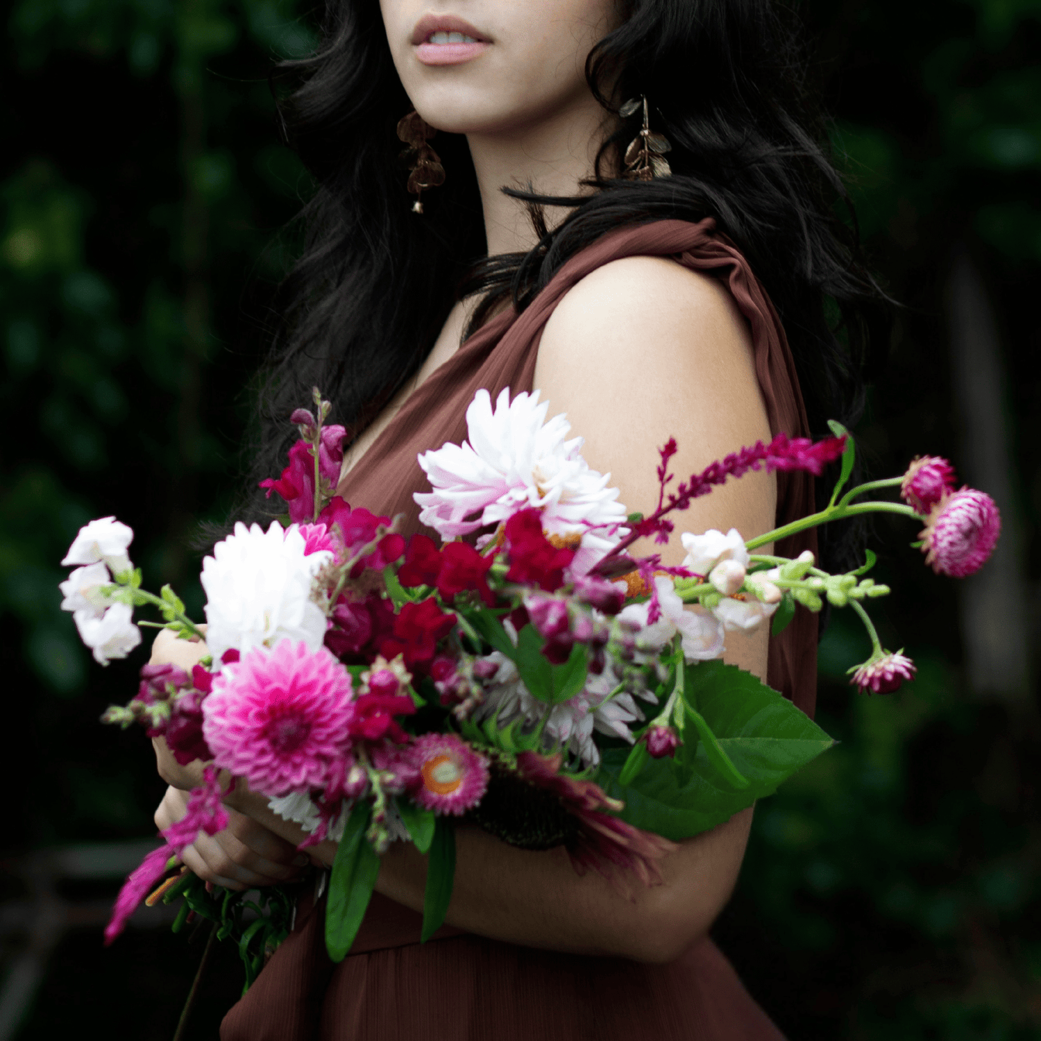 Teenage girl holding a bouquet of dahlias, strawflowers, roses and snapdragons grown & arranged by Little Mountain Flowers