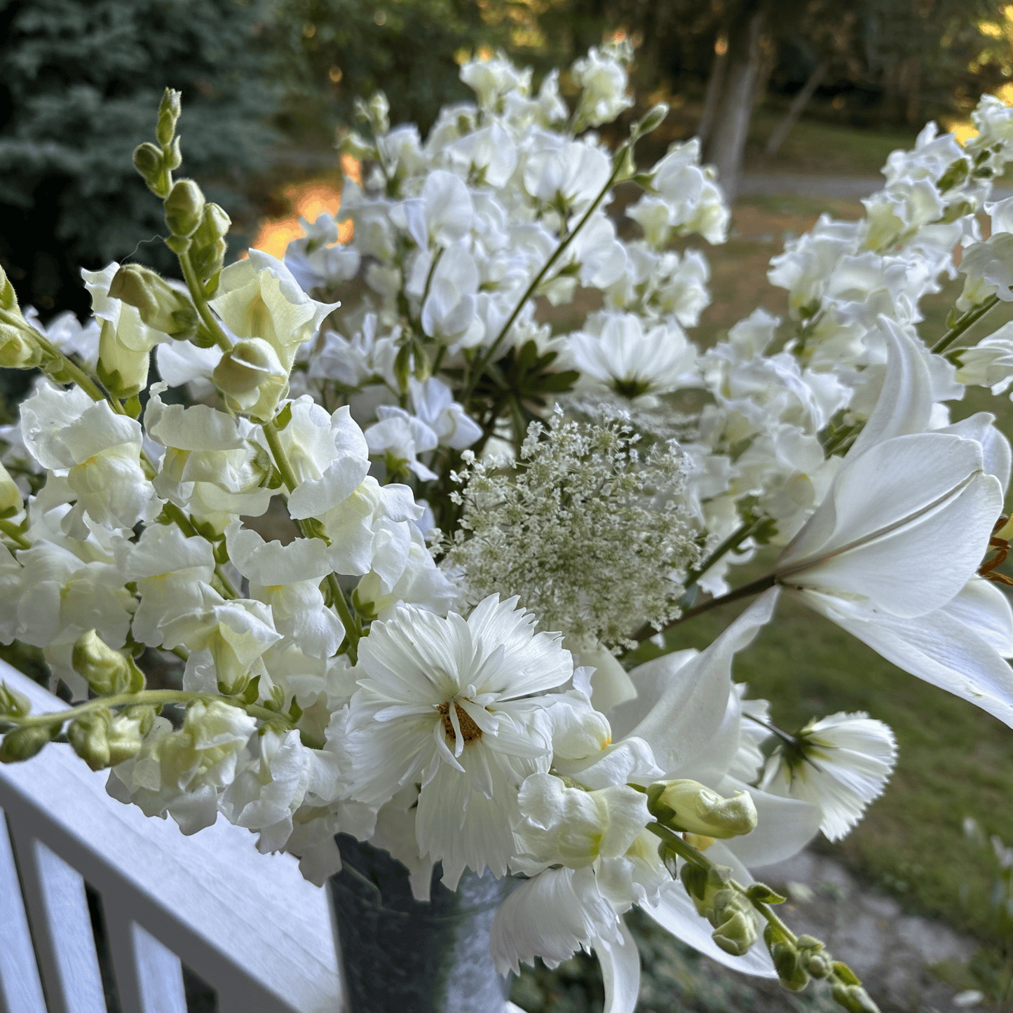 Lilies, cosmos, snapdragons, queen and Anne's lace grown & arranged in a galvanized metal vase by Little Mountain Flowers