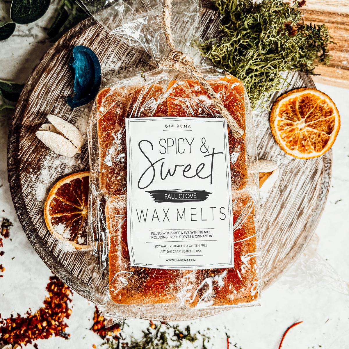 Packaged spicy and sweet XL wax melts with a label on a wooden board with decorative elements.