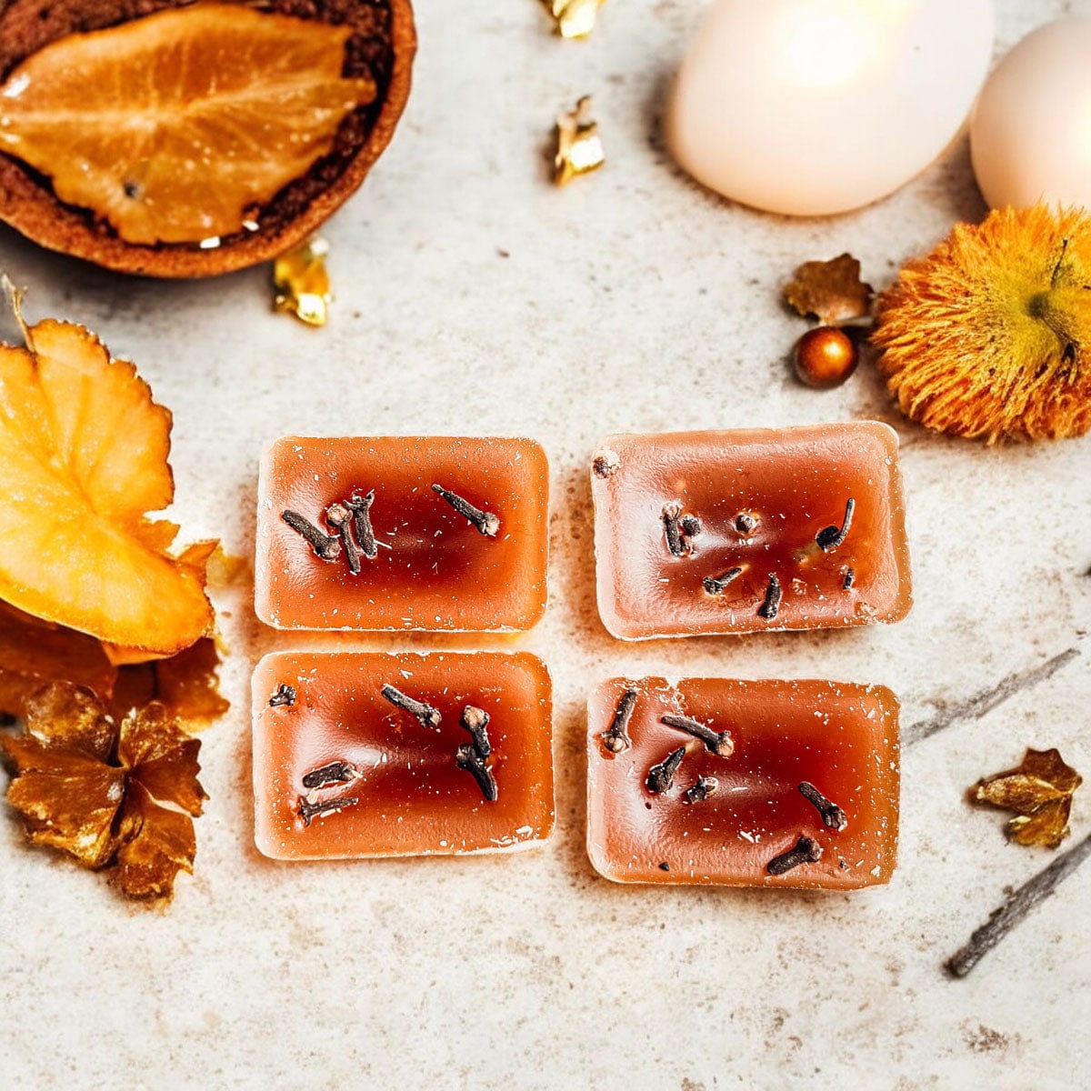4 XL Spicy & Sweet Fall Clove wax melts on a wooden board with decorative fall leaves and elements.